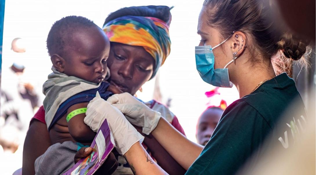 Medical intern, Devon, helps a child in Kenya Medical intern helping children in Kenya